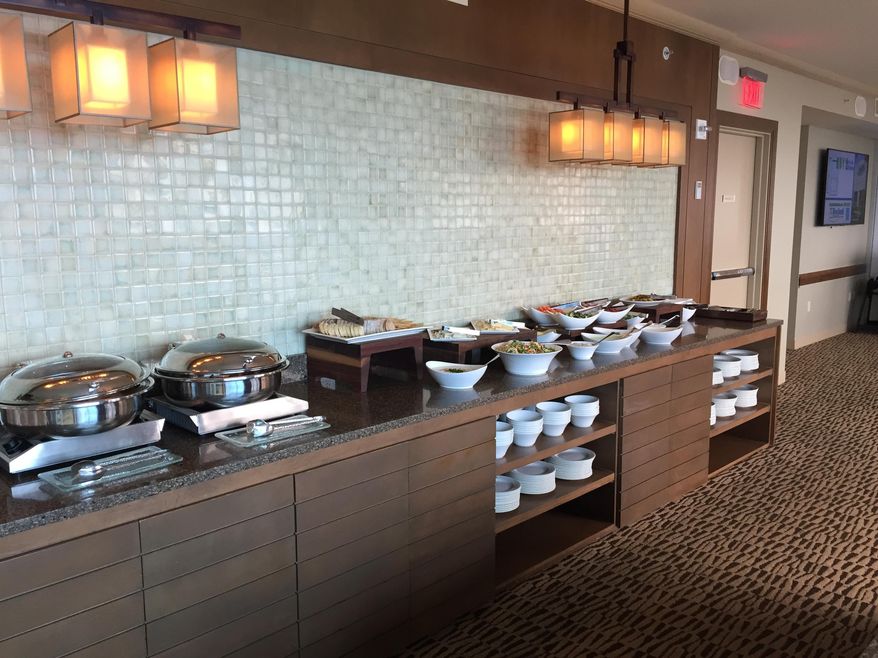 This Thursday, May 11, 2017, photo shows free afternoon snacks provided to elite guests at the Regency Club at the Hyatt Regency Orlando, in Orlando, Fla. Summer travelers may well find themselves stuck in long security lines and squeezed into cramped seats. For frequent travelers, or those who can and want to pay extra, perks are available including upgrades to first-class seats, airport lounges and free food. (AP Photo/Scott Mayerowitz)