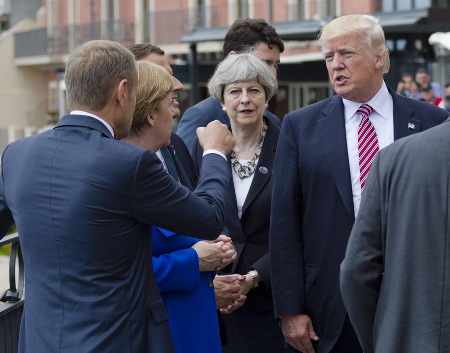 From left, President of the European Council Donald Tusk gesticulates as he talks with German Chancellor Angela Merkel, French newly elected President Emmanuel Macron, partially hidden, British PM Theresa May, and US President Donal Trump prior to the start of the leaders of the G7 countries summit in the Sicilian citadel of Taormina, Italy, Friday, May 26, 2017. On Friday and Saturday, for the first time all seven are around the same table, including also newcomers Macron, May and the Italian host, Paolo Gentiloni -- forging a new dynamic after a year of global political turmoil amid a rise in nationalism. (AP Photo/Salvatore Cavalli)