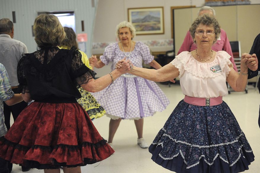 ADVANCE FOR WEEKEND EDITIONS - In this April 22, 2017, photo, Marlene Bauer swings at a Dudes 'n' Dolls dance at the Missouri River Manor in Great Falls, Mont. The club will welcome square dancers from across the state to Great Falls on Memorial Day Weekend. (Julia Moss/The Great Falls Tribune via AP)