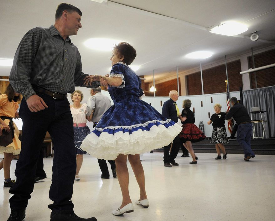 ADVANCE FOR WEEKEND EDITIONS - In this April 22, 2017, photo, The Dudes 'n' Dolls enjoy a dance at the Missouri River Manor in Great Falls, Mont. The club will welcome square dancers from across the state to Great Falls on Memorial Day Weekend. (Julia Moss/The Great Falls Tribune via AP)