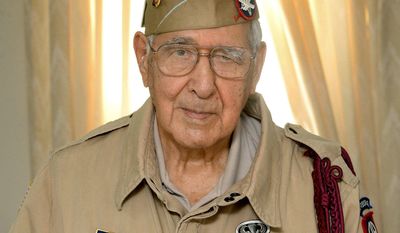 In this May 18, 2017, photo, Joseph Morettini, 92, center, of Erie, Pa., poses for a photo. In the early morning hours of D-Day, June 6, 1944,  Morettini, a 19-year-old paratrooper with the U.S. Army 82nd Airborne Division, jumped from a Douglas C-47 Skytrain over France’s Normandy coast. (Jack Hanrahan/Erie Times-News via AP)