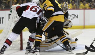 Pittsburgh Penguins goalie Matt Murray, right, blocks a shot by Ottawa Senators right wing Mark Stone (61) as Stone shoots against the Penguins defenseman Brian Dumoulin (8) during the first period of Game 7 in the NHL hockey Stanley Cup Eastern Conference finals, Thursday, May 25, 2017, in Pittsburgh. (AP Photo/Keith Srakocic)