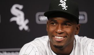Cuban outfielder Luis Robert smiles at a news conferences after signing with the Chicago White Sox before a baseball game between the White Sox and the Detroit Tigers on Saturday, May 27, 2017, in Chicago. (AP Photo/Charles Rex Arbogast)