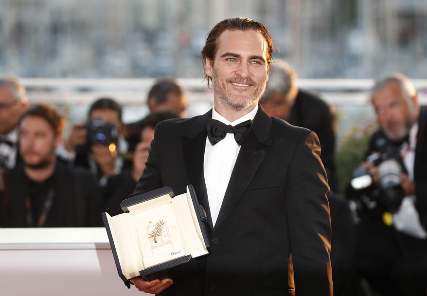 Actor Joaquin Phoenix with his Best Actor award for the film You Were Never Really Here poses for photographers during a photo call following the awards ceremony at the 70th international film festival, Cannes, southern France, Sunday, May 28, 2017. (AP Photo/Thibault Camus)