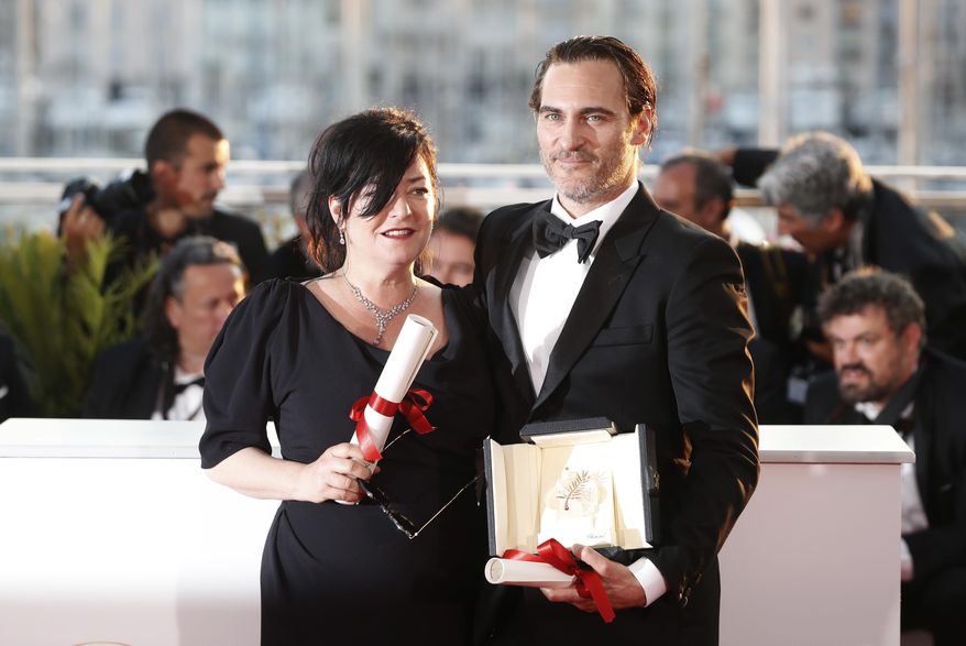 Directors Lynne Ramsay, left, with her joint Best screenplay award and actor Joaquin Phoenix with his Best Actor award both for the film You Were Never Really Here, pose for photographers during a photo call following the awards ceremony at the 70th international film festival, Cannes, southern France, Sunday, May 28, 2017. (AP Photo/Thibault Camus)