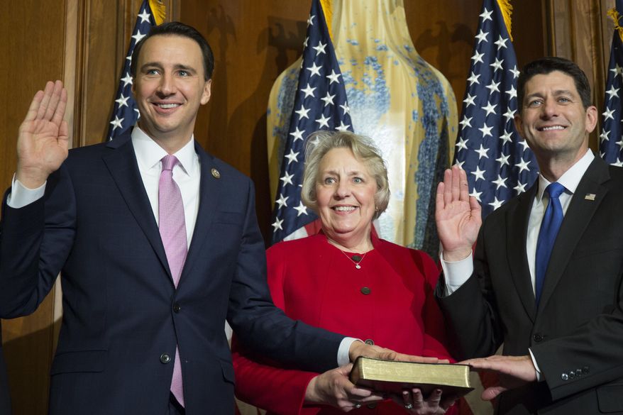 FILE - In this Jan. 3, 2017, file photo, House Speaker Paul Ryan of Wis. administers the House oath of office to Rep. Ryan Costello, R-Pa., during a mock swearing in ceremony on Capitol Hill in Washington. Democrats hope to enlist military veterans in another type of fight _ for majority control of the House. In the Philadelphia suburbs, former Air Force officer Chrissy Houlahan is challenging Costello in one of 23 districts where Democrat Hillary Clinton topped Trump in November. (AP Photo/Zach Gibson, File)