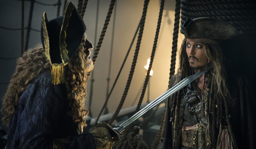 In this image released by Disney, Geoffrey Rush portrays Barbossa, left, and Johnny Depp portrays Captain Jack Sparrow in a scene from &amp;quot;Pirates of the Caribbean: Dead Men Tell No Tales.&amp;quot; (Peter Mountain/Disney via AP)