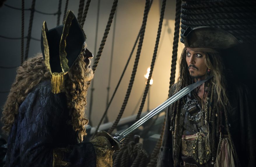 In this image released by Disney, Geoffrey Rush portrays Barbossa, left, and Johnny Depp portrays Captain Jack Sparrow in a scene from &amp;quot;Pirates of the Caribbean: Dead Men Tell No Tales.&amp;quot; (Peter Mountain/Disney via AP)