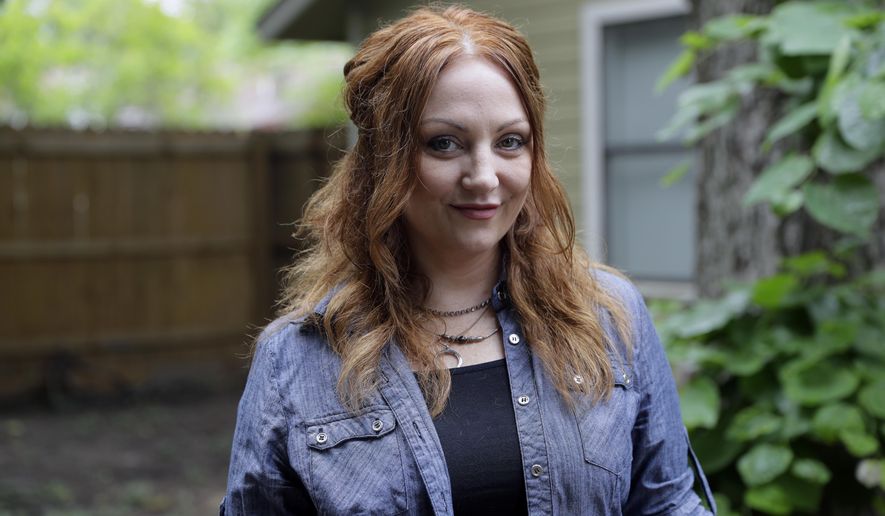 In this Tuesday, May 23, 2017, photo, Dawn Erin poses for a photo at her home, in Austin, Texas. Erin was among more than 20 million Americans who gained coverage under Affordable Care Act. The health law helped push uninsured rates to historic lows and also aimed to bring the newly insured back into the primary care system to improve their health. (AP Photo/Eric Gay)
