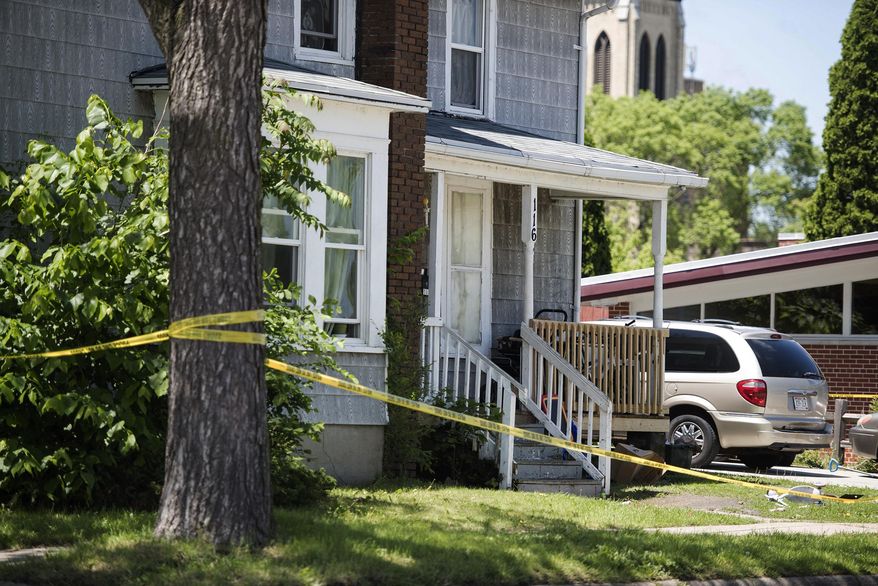 Janesville Police continue to monitor a house at 116 S. Franklin St. in Janesville, Wis. following an early morning homicide on Sunday, May 28, 2017. (Angela Major/The Janesville Gazette via AP)