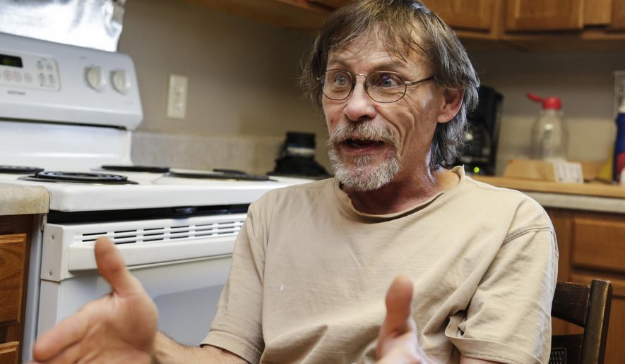 In this May 25, 2017 photo, Glenn Sharp, who sat out fines in jail, gestures in his Lincoln, Neb., apartment. Nebraska's largest county corrections departments spend millions each year incarcerating people who couldn't pay routine fines or afford bail, sometimes for nonviolent misdemeanors that wouldn't result in jail time. Advocates are optimistic that a law passed this session requiring judges to consider whether someone can afford a fine or bail before assigning it will keep more poor people out of jail. (AP Photo/Nati Harnik)