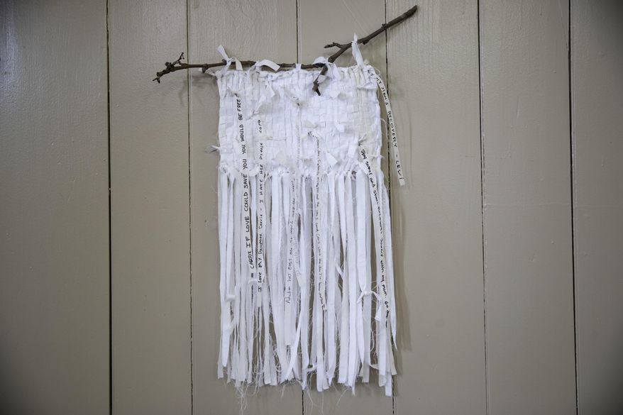 This Wednesday, May 24, 2017 photo shows part of Lisa Kelley's "Epidemic" at the Arch Street Friends Meeting House in Philadelphia. The "Revolutionary: A Pop-Up Street Art Exhibition" on display until July 4, features 13 artists who created works that challenge the status quo. (Revolutionary: A Pop-Up Street Art Exhibition via AP)