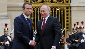 Russian President Vladimir Putin, right, and French President Emmanuel Macron pose for a photo at the Palace of Versailles, near Paris, France, Monday, May 29, 2017. Monday&#39;s meeting comes in the wake of the Group of Seven&#39;s summit over the weekend where relations with Russia were part of the agenda, making Macron the first Western leader to speak to Putin after the talks. (AP Photo/Alexander Zemlianichenko, pool)