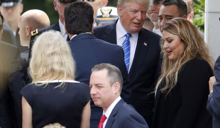 President Donald Trump, center, talks with Jane Horton, right, at the Memorial Amphitheater in Arlington National Cemetery in Arlington, Va., Monday, May 29, 2017, after speaking at a Memorial Day ceremony. Horton&#x27;s husband Army Spc. Christopher Horton, was killed in Afghanistan in 2011. Also in attendance is White House Chief of Staff Reince Priebus. (AP Photo/Pablo Martinez Monsivais)