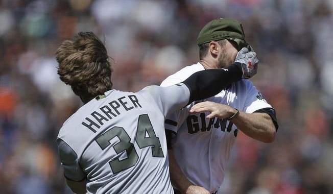 Washington Nationals&#x27; Bryce Harper (34) hits San Francisco Giants&#x27; Hunter Strickland in the face after being hit with a pitch in the eighth inning of a baseball game Monday, May 29, 2017, in San Francisco. (AP Photo/Ben Margot)