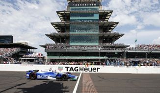Takuma Sato, of Japan, celebrates as he crosses the Yard of Bricks to win the Indianapolis 500 auto race at Indianapolis Motor Speedway, Sunday, May 28, 2017, in Indianapolis. (AP Photo/Rob Baker)