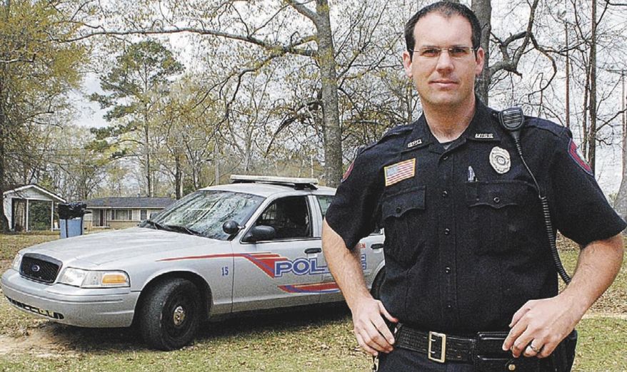 In this is a Spring 2014 photo Brookhaven Police officer William Durr poses for a photo next to his police car in Brookhaven, Miss. Durr, a deputy sheriff of the Lincoln County Sheriff's Department, was killed Saturday, May 27, 2017, as he reported to a domestic dispute in Bogue Chitto, a small community near Brookhaven. Authorities say a gunman went on a house-to-house rampage in rural Mississippi, killing several people including his mother-in-law and Durr. (Rhonda Dunaway/The Daily Leader via AP)