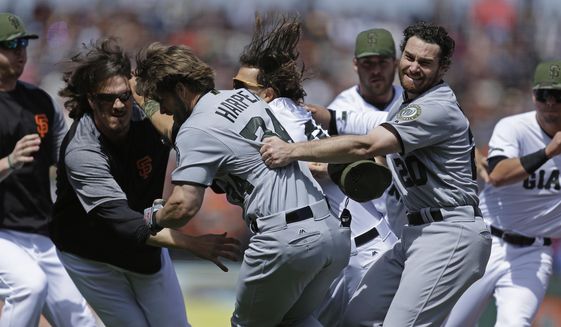 Washington Nationals&#39; Daniel Murphy (20) tries to restrain teammate Bryce Harper (34) after Harper charged San Francisco Giants&#39; Hunter Strickland after being hit with a pitch in the eighth inning of a baseball game Monday, May 29, 2017, in San Francisco. (AP Photo/Ben Margot)