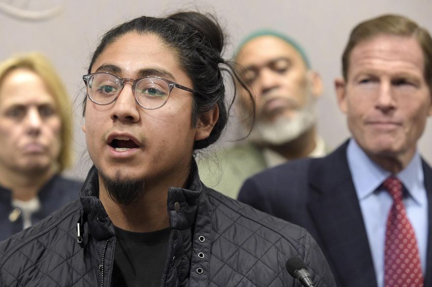 In this Jan. 1, 2017, photo, University of Connecticut student Eric Cruz Lopez, 21, speaks about his experience as an undocumented immigrant at a news conference on Friday in Hartford, Conn., at the Legislative Office Building. Cruz was charged on May 7 with more than 100 counts of misdemeanor vandalism after police say he spray-painted expletives about President Donald Trump on the walls of school buildings. (Patrick Raycraft/Hartford Courant via AP)