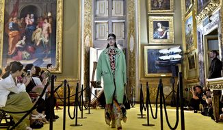 A model presents a creation of the Gucci &#39;Cruise&#39; collection, at the Pitti Palace in Florence, Italy, Monday, May 29, 2017. The event was organized on the occasion of the presentation of Gucci&#39;s cultural project, aimed at raising funds to restore the Boboli Gardens. (Maurizio Degl&#39;Innocenti/ANSA via AP)