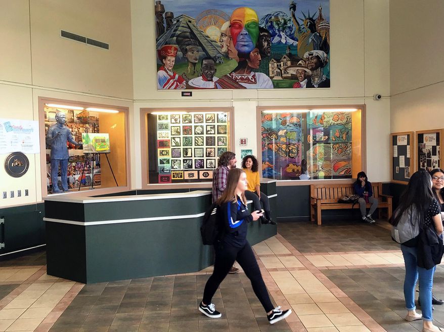 In this May 12, 2017, photo, a student walks through the front lobby of Woodburn High School in Woodburn, Ore. Teresa Alonso Leon, one of the first people brought to the U.S. illegally to become a lawmaker in America, has been making an impact as the first Latina immigrant member of the Oregon Legislature. “Our Latino students see her as inspirational,” said Victor Vergara, principal of the high school’s Academy of International Studies. (AP Photo/Andrew Selsky)