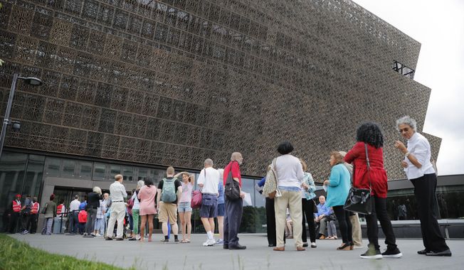 In this May 1, 2017, file photo, people wait in line to enter the Smithsonian National Museum of African American History and Culture on the National Mall in Washington. (AP Photo/Pablo Martinez Monsivais) ** FILE **