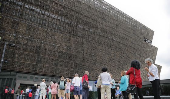 In this May 1, 2017, file photo, people wait in line to enter the Smithsonian National Museum of African American History and Cultural on the National Mall in Washington. After a firestorm of controversy, the museum has removed a &quot;whiteness&quot; graphic that ascribed traits such as &quot;hard work,&quot; &quot;self-reliance,&quot; &quot;delayed gratification,&quot; being on time, and politeness to &quot;white culture.&quot; (AP Photo/Pablo Martinez Monsivais) ** FILE **