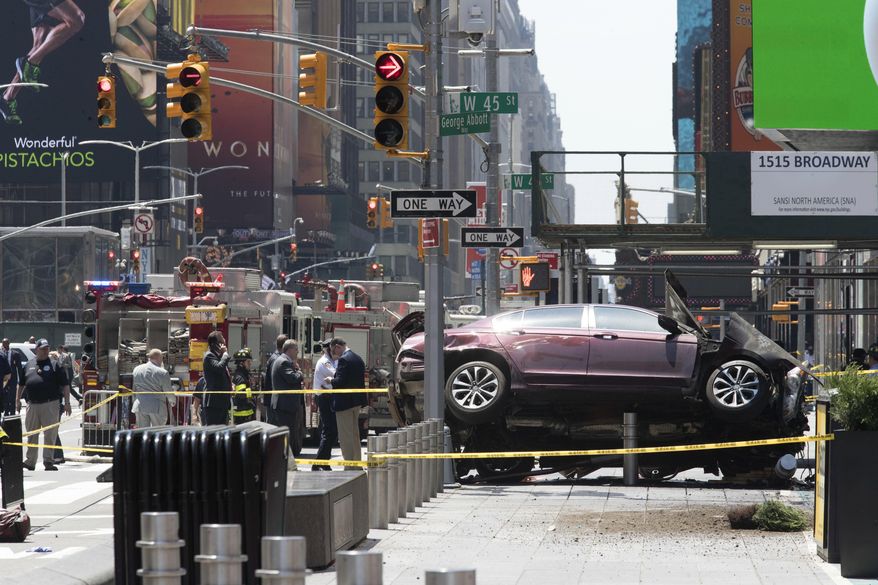 FILE - In this Thursday, May 18, 2017 file photo, a car rests on a security barrier in New York's Times Square after driving through a crowd of pedestrians, injuring at least a dozen people. A three-foot-tall piece of stainless steel in the ground ultimately stopped a speeding Honda Accord as it barreled down the crowded sidewalks of Times Square this week. The vehicle rampage that killed a teenage tourist in New York's Times Square is spurring calls to further restrict cars from the so-called Crossroads of the World. (AP Photo/Mary Altaffer, File)