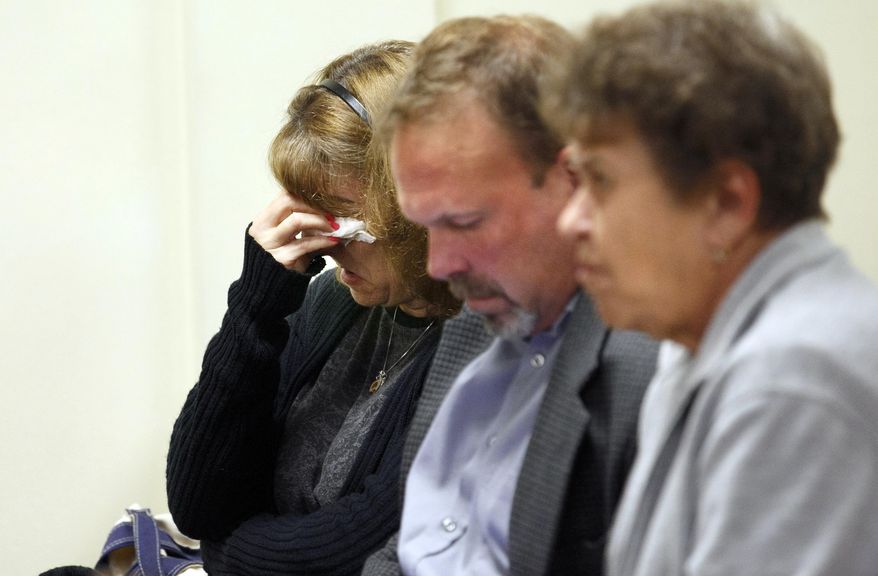 Lisa Creato, left, mother of defendant David "D.J." Creato Jr., sitting wither her husband David Creato Sr., center, uses a tissue after Judge John Kelley announced that the jury was unable reach a verdict after five days of deliberations in her son's murder trial, Wednesday, May 31, 2017, at the Camden County Courthouse in Camden, N.J. Judge Kelley declared a mistrial one day after the jury first told him they couldn't agree on a verdict against Creato accused of killing his 3-year-old son. ( Jessica Griffin/The Philadelphia Inquirer via AP, Pool)