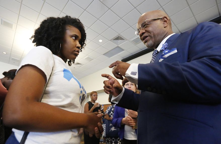 Jackson State student Sherrell Ford questions current Mississippi Valley State President William Bynum during a visit to the Jackson, Miss., school, Wednesday, May 31, 2017. Bynum, the preferred choice by the college board, was later introduced by the board as Jackson State's 11th president. (AP Photo/Rogelio V. Solis)
