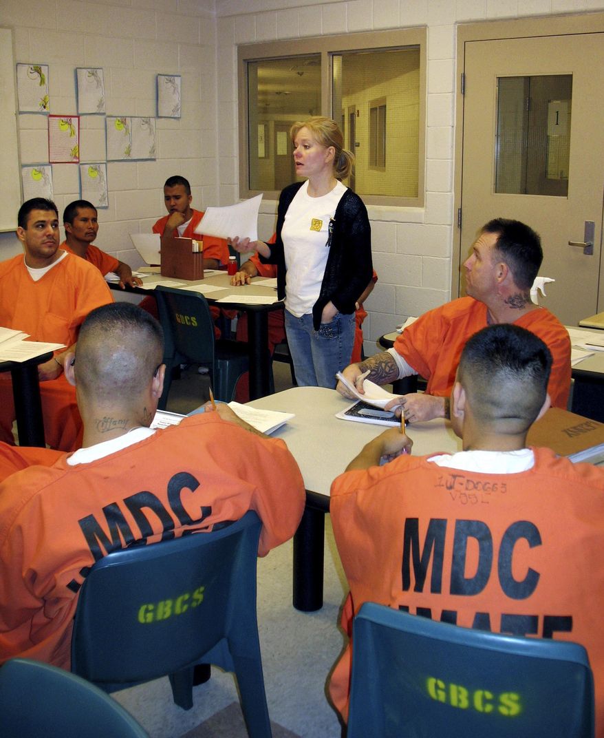 FILE - In this Sept. 23, 2008 file photo instructor Kimberlee Hanson discusses an assignment with student inmates at the Gordon Bernell Charter School in the Bernalillo County Metropolitan Detention Center in Albuquerque, N.M. The Massachusetts-based Prison Policy Initiative, a criminal justice reform group, said in a study released Wednesday, May 31, 2017, Georgia and New Mexico, two states with some of the nation's largest percentages of minority residents, also had the country's highest jail incarceration rates in 2013. (AP Photo/Heather Clark,File)