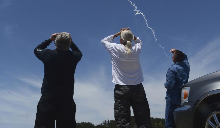 From Harris Grade Road north of Lompoc, Calif., spectators watch an interceptor missile launch from an underground silo at Vandenberg Air Force Base, and fly toward an intercontinental-range missile fired from a test range on Kwajalein Atoll in the Pacific. Hit or miss, the Pentagon's attempt on Tuesday, May 30, 2017, to shoot down a mock warhead over the Pacific Ocean marks an important milestone for an oft-criticized defense program that could be what stands between an incoming North Korean strike and the United States. (Len Wood /The Santa Maria Times via AP)