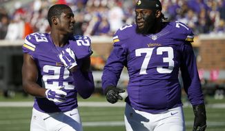 FILE - In this Sunday, Oct. 15, 2015 file photo, Minnesota Vikings cornerback Xavier Rhodes (29) and defensive tackle Sharrif Floyd (73) walk on the field before an NFL football game against the Kansas City Chiefs in Minneapolis. Minnesota Vikings defensive tackle Sharrif Floyd remains sidelined indefinitely because of complications from surgery on his right knee last September. The 2013 first-round draft pick spoke to reporters Wednesday, May 31, 2017 for the first time in more than six months, after watching practice. (AP Photo/Ann Heisenfelt, File)