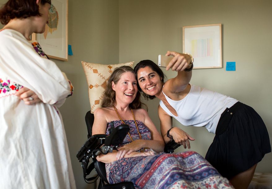 In this Sunday, July 24, 2016 photo provided by Niels Alpert, Betsy Davis poses for a photo with her longtime friend Susan Delmonico during her "Right To Die Party" in Ojai, Calif. At the end of the party, the 41-year-old woman diagnosed with ALS took a cocktail of lethal drugs and died, becoming one of the first California residents to take life-ending drugs under a new law that gave such an option to the terminally ill. At least 504 terminally ill Californians have requested a prescription for life-ending drugs since a state law allowing physician-assisted deaths went into effect in June 2016. (Niels Alpert via AP)