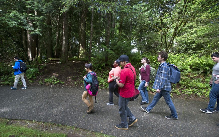 Students leave The Evergreen State College campus in Olympia after a threat prompted a student alert and evacuation on Thursday, June 1, 2017. The announcement posted on the school's website Thursday asked everyone to leave the Olympia campus or return to residence halls for further instructions. The post did not provide other details. (Tony Overman /The Olympian via AP)
