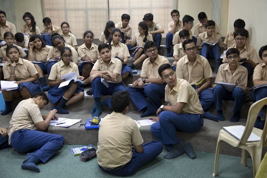 In this Wednesday, April 26, 2017 photo, Rohin Sarin, front row right, and his classmates listen to their math teacher inside a classroom in New Delhi, India. Rohin is one of a growing number of Indians with diabetes, with the disease increasingly afflicting children and adolescents in the fast-growing South Asian country. Nearly 30 percent of India’s teenagers are obese, nearly twice the number in 2010, according to health ministry statistics. (AP Photo /Tsering Topgyal)