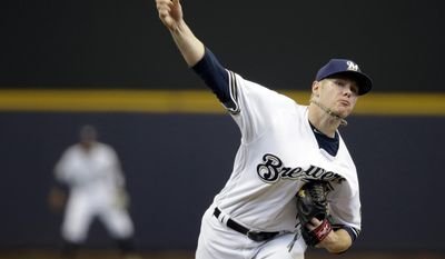 FILE - In this April 6, 2017, file photo, Milwaukee Brewers starting pitcher Chase Anderson throws to the Colorado Rockies during the first inning of a baseball game in Milwaukee. Anderson (3-1) starts for the NL Central-leading Brewers in the Friday, June 1, finale of a four-game series at the New York Mets. Anderson had a no-hit bid going last Saturday until Nick Ahmed's leadoff single in the eighth at Arizona. (AP Photo/Jeffrey Phelps, File)