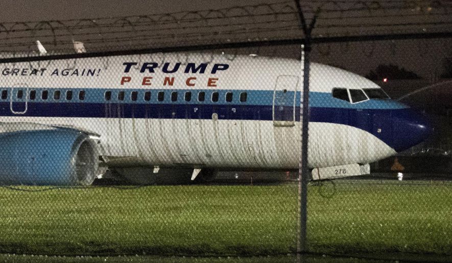 FILE- In this Oct. 27, 2016 file photo, Republican vice presidential candidate and Indiana Gov. Mike Pence's campaign airplane sits partially on the tarmac and the grass after sliding off the runway while landing at LaGuardia airport in New York. The pilots of the plane knew they were going to be in the news according to the Boeing 737's cockpit voice recording released by the National Transportation Safety Board, Wednesday, May 31, 2017. (AP Photo/Mary Altaffer, File)
