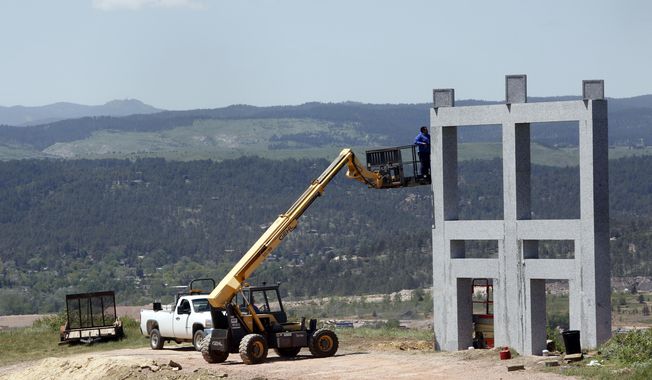 Construction continues Wednesday, May 31, 2017, on a sculpture park near the northwestern part of Hanson-Larsen Memorial Park in Rapid City, S.D. According to city documents, the private park is being constructed by Bailey Associates and would feature a series of granite structures like this one where patrons may have dedication plaques installed.  (Chris Huber/Rapid City Journal via AP)