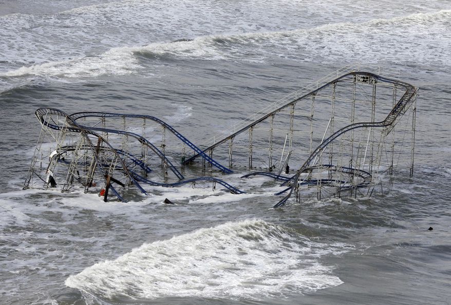 FILE - In this Wednesday, Oct. 31, 2012 file photo, waves wash over a roller coaster from a Seaside Heights, N.J., amusement park that fell in the Atlantic Ocean during Superstorm Sandy. Meteorologists are now as good with their five-day forecasts as they were with their three-day forecasts in 2005. Both government and private weather forecasting companies are approaching the point where they get tomorrow’s high temperature right nearly 80 percent of the time. It was 66 percent 11 years ago, according to ForecastWatch, a private firm that rates accuracy of weather forecasts. (AP Photo/Mike Groll, File)