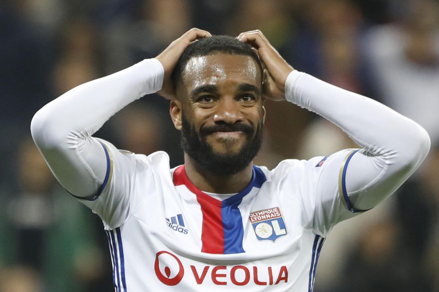 FILE - This is a Thursday, May 11, 2017 file photo, of Lyon&#39;s Alexandre Lacazette  as he grabs his head after teammate Fakir missed a chance to score during the second leg semi final soccer match between Olympique Lyon and Ajax in the Stade de Lyon,  Decines, France. Atletico Madrid’s transfer ban was upheld by the Court of Arbitration for Sport on Thursday June 1, 2017, harming Manchester United’s hopes of signing Antoine Griezmann. The FIFA ban prevents Atletico from registering new players until January. Atletico had lined up Lyon forward Alexandre Lacazette as a potential replacement for Griezmann.(AP Photo/Laurent Cipriani/File)