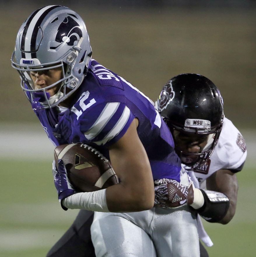 FILE - In this Sept. 24, 2016, file photo, Kansas State wide receiver Corey Sutton (12) is tackled by Missouri State cornerback Matt Rush during the first half of an NCAA college football game in Manhattan, Kan. Kansas State coach Bill Snyder is defending his choice not to grant a wide receiver a release from his scholarship, a decision that has sparked controversy around his program. Corey Sutton announced his desire to transfer, claiming Snyder did not follow through on certain promises of playing time. Snyder said Thursday night, June 1, 2017, that his view is that players make a commitment to the program when they sign a national letter of intent, just as the program makes a commitment to them with a scholarship. (AP Photo/Orlin Wagner, File)
