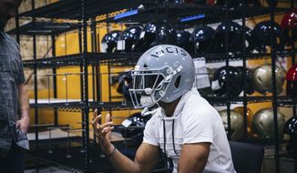 In this April 26, 2017, image provided by VICIS, Inc., Seattle Seahawks NFL football player Doug Baldwin talks about the new VICIS Zero 1 helmet that NFL teams will be trying out at minicamps, at the a fabrication facility in Seattle. The Zero 1 is the first to account for rotational as well as linear impact. Scientific studies have indicated that rotational impact has more correlation with concussions. (Randy Ronquillo/VICIS Inc. via AP)
