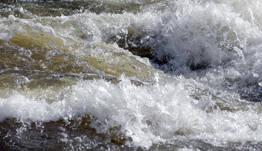 In this Wednesday, May 31, 2017, photo, fast-flowing water races down the Weber River, in Oakley, Utah. Authorities in Utah are ratcheting up warnings telling people to stay away from the raging, icy waterways that are extremely dangerous this spring due to a snowy winter and wet spring. (AP Photo/Rick Bowmer)