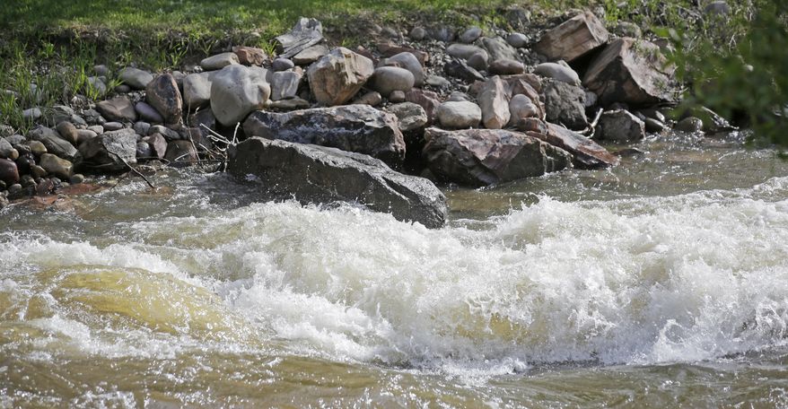 In this Wednesday, May 31, 2017, photo, fast-flowing water races down the Weber River, in Oakley, Utah. Authorities in Utah are ratcheting up warnings telling people to stay away from the raging, icy waterways that are extremely dangerous this spring due to a snowy winter and wet spring. (AP Photo/Rick Bowmer)