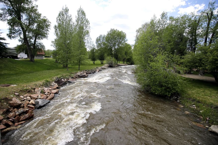 In this Wednesday, May 31, 2017, photo, fast-flowing water races down the Weber River, in Oakley, Utah. Authorities in Utah are ratcheting up warnings telling people to stay away from the raging, icy waterways that are extremely dangerous this spring due to a snowy winter and wet spring. (AP Photo/Rick Bowmer)