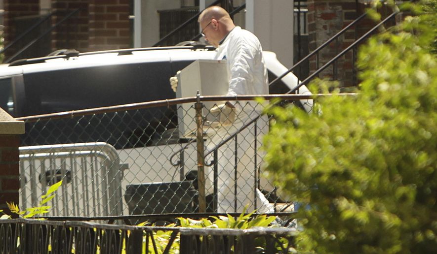 FILE - In this July 14, 2011 file photo, crime scene investigators collect evidence from the home of Levi Aron, who later pleaded guilty to abducting and killing 8-year-old boy Leiby Kletzky, in the Brooklyn borough of New York. On Friday, June 2, 2017, a law enforcement official said Levi's brother, Tzvi Aron, was found dead, his body bound, wrapped in a blanket and stuffed in a basement closet in the same Brooklyn home where detectives uncovered the remains of the boy. (AP Photo/Seth Wenig, File)