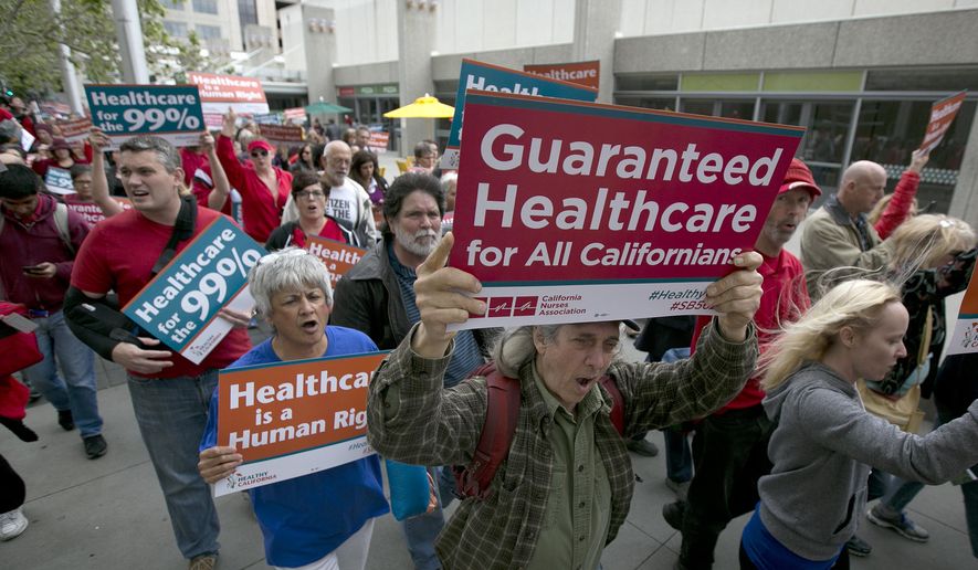 In this April 26, 2017 file photo supporters of single-payer health care march to the Capitol in Sacramento, Calif. A poll released on April 13, 2018, finds that a slim majority of Americans now support the idea of a government-run single-payer health care system. (AP Photo/Rich Pedroncelli file) **FILE**