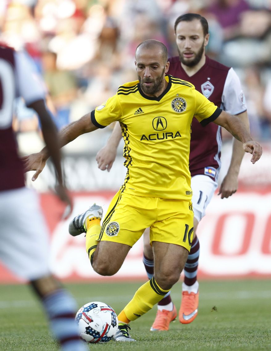 Columbus Crew forward Federico Higuain, front, kicks the ball as Colorado Rapids midfielder Shkelzen Gashi pursues in the first half of an MLS soccer game Saturday, June 3, 2017, in Commerce City, Colo. (AP Photo/David Zalubowski)