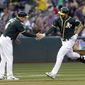 Oakland Athletics&#39; Matt Joyce, right, is congratulated by third base coach Chip Hale (4) after hitting a two-run home run off Washington Nationals&#39; Stephen Strasburg in the third inning of a baseball game Friday, June 2, 2017, in Oakland, Calif. (AP Photo/Ben Margot)
